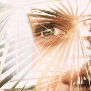 Abstract image of leaves overlaid with the image of a face